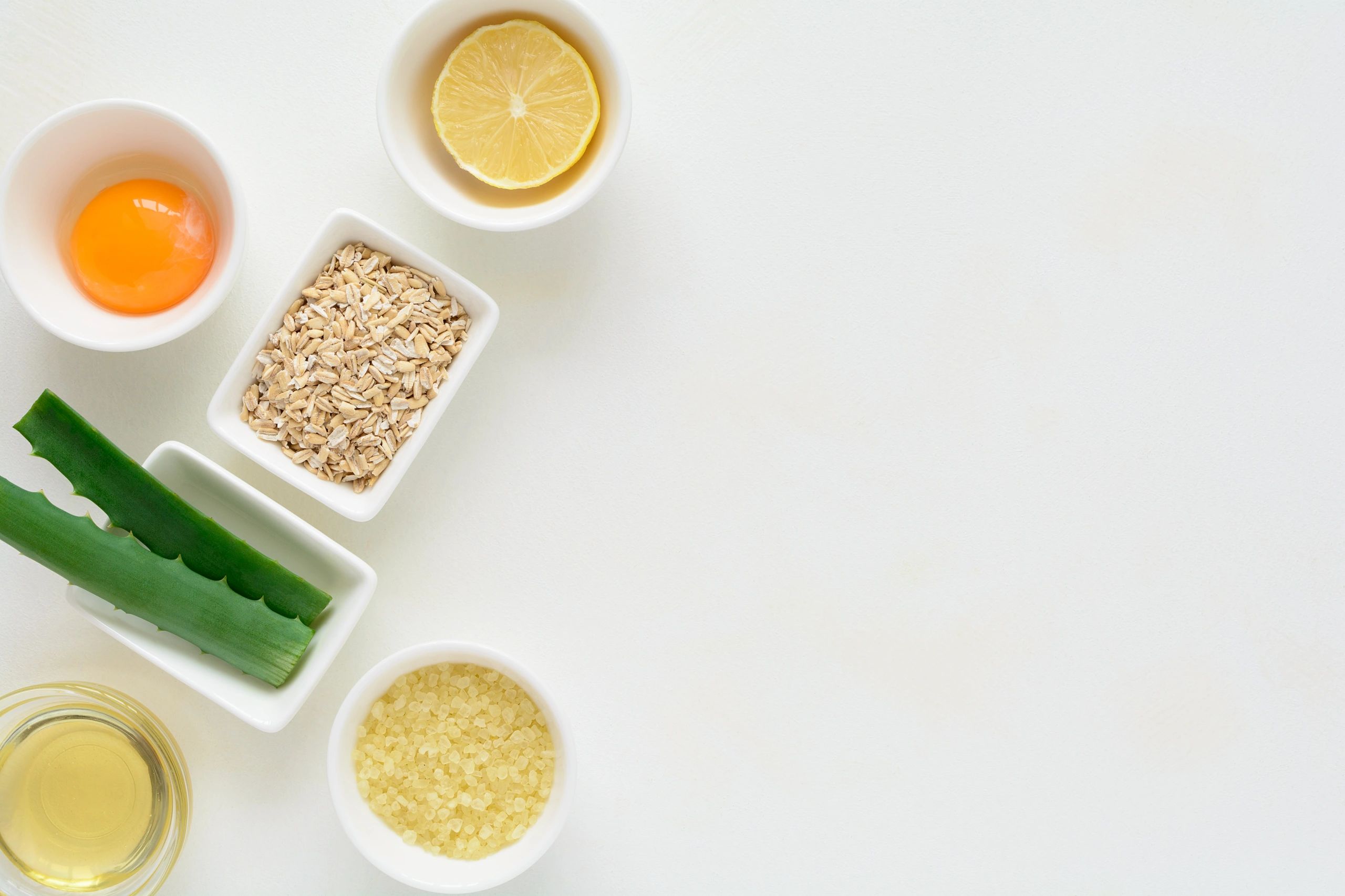 Fresh DIY skincare ingredients on a white background flat lay