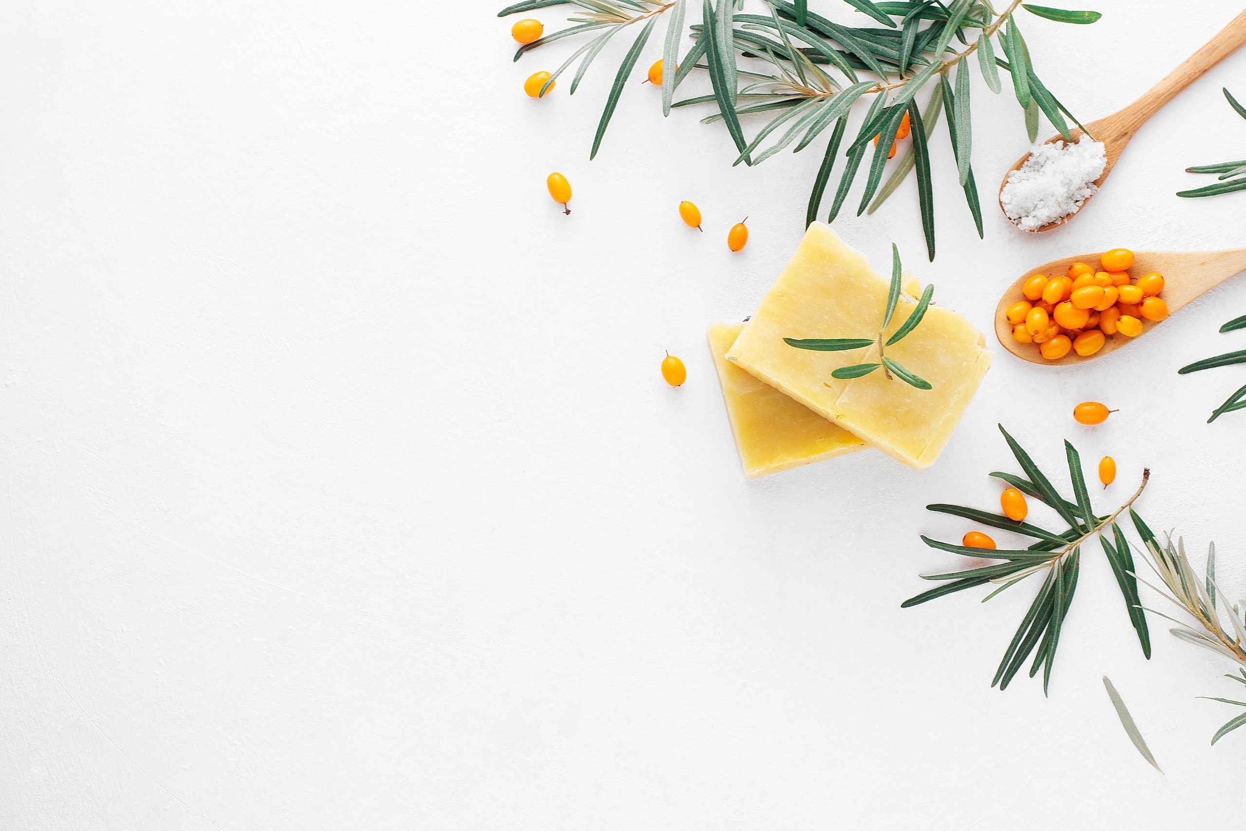 Handmade herbal soap with ingredients on a white background